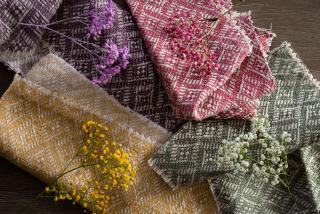 Pink, purple, yellow and green woven fabrics with matching flowers